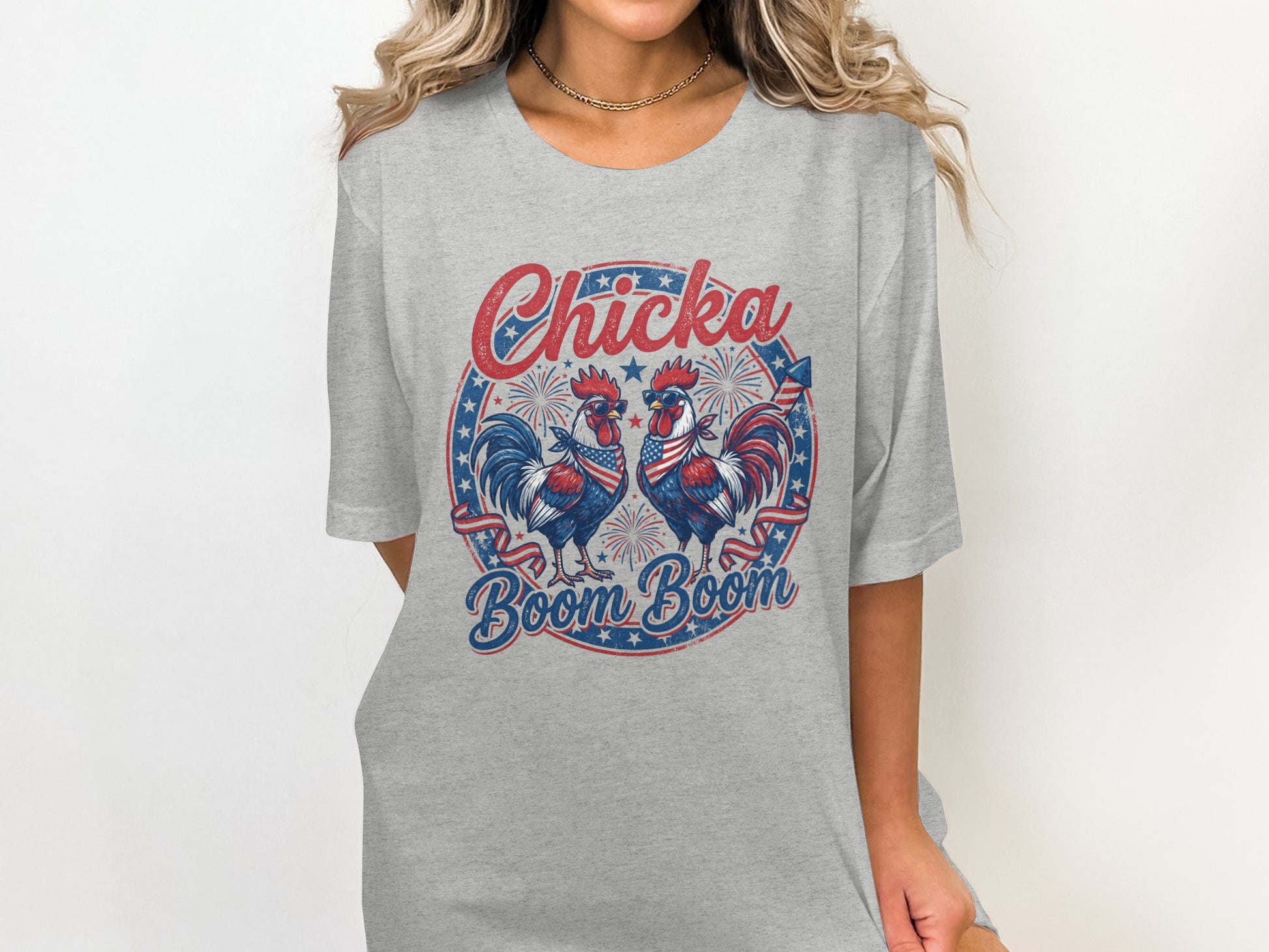 Two patriotic roosters on a grey t-shirt with "Chicka Boom Boom" text.