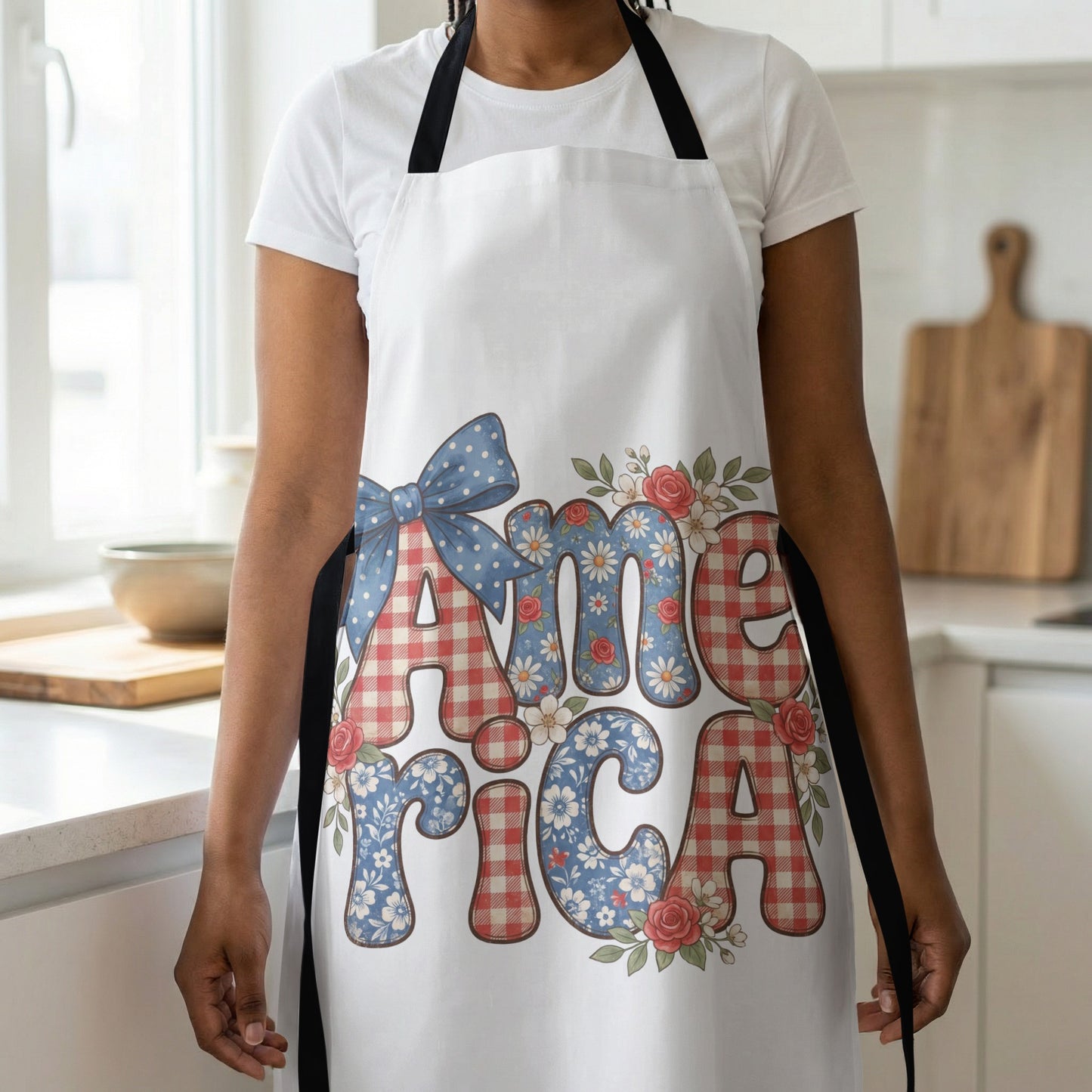 White apron with red gingham and floral "America" text and bow.
