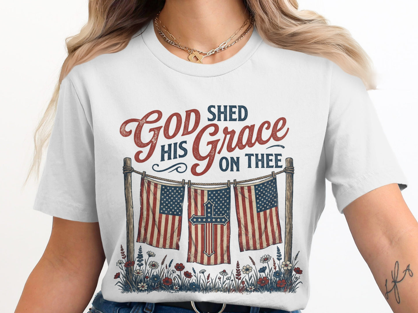 White t-shirt with American flags, a cross, and "God Shed His Grace On Thee".