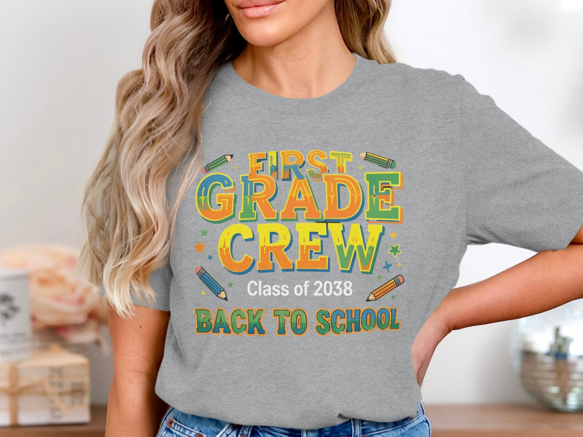 Grey t-shirt with "First Grade Crew Class of 2038 Back to School" text and pencils.
