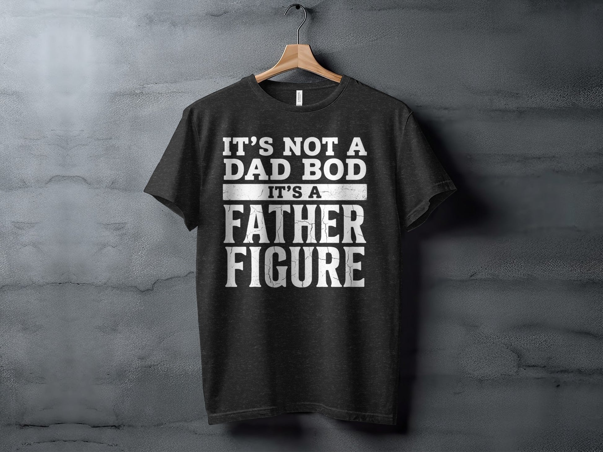 Dark t-shirt with white text: "It's not a dad bod, it's a father figure."