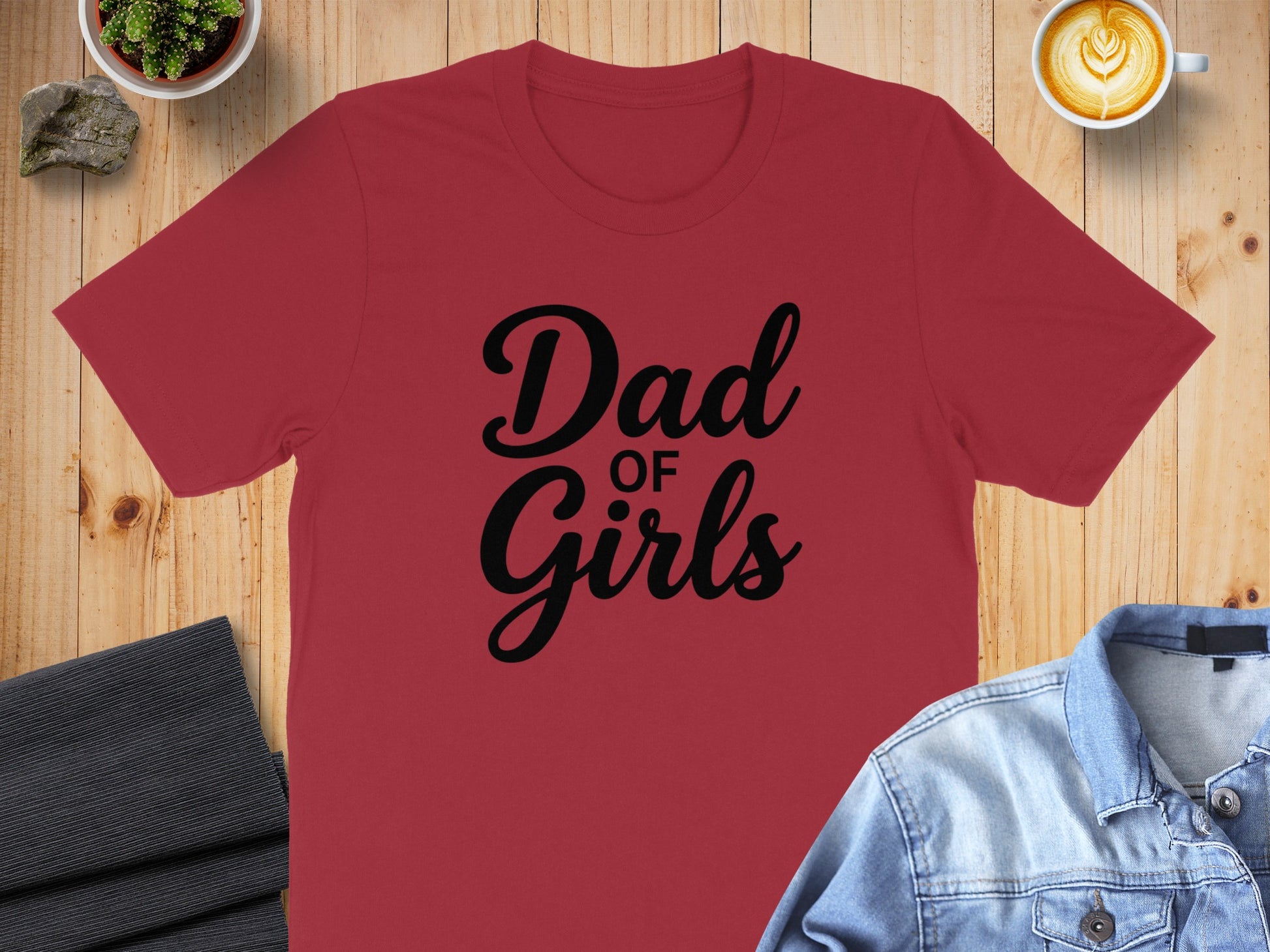 Red t-shirt with "Dad of Girls" text, styled with denim jacket and coffee.
