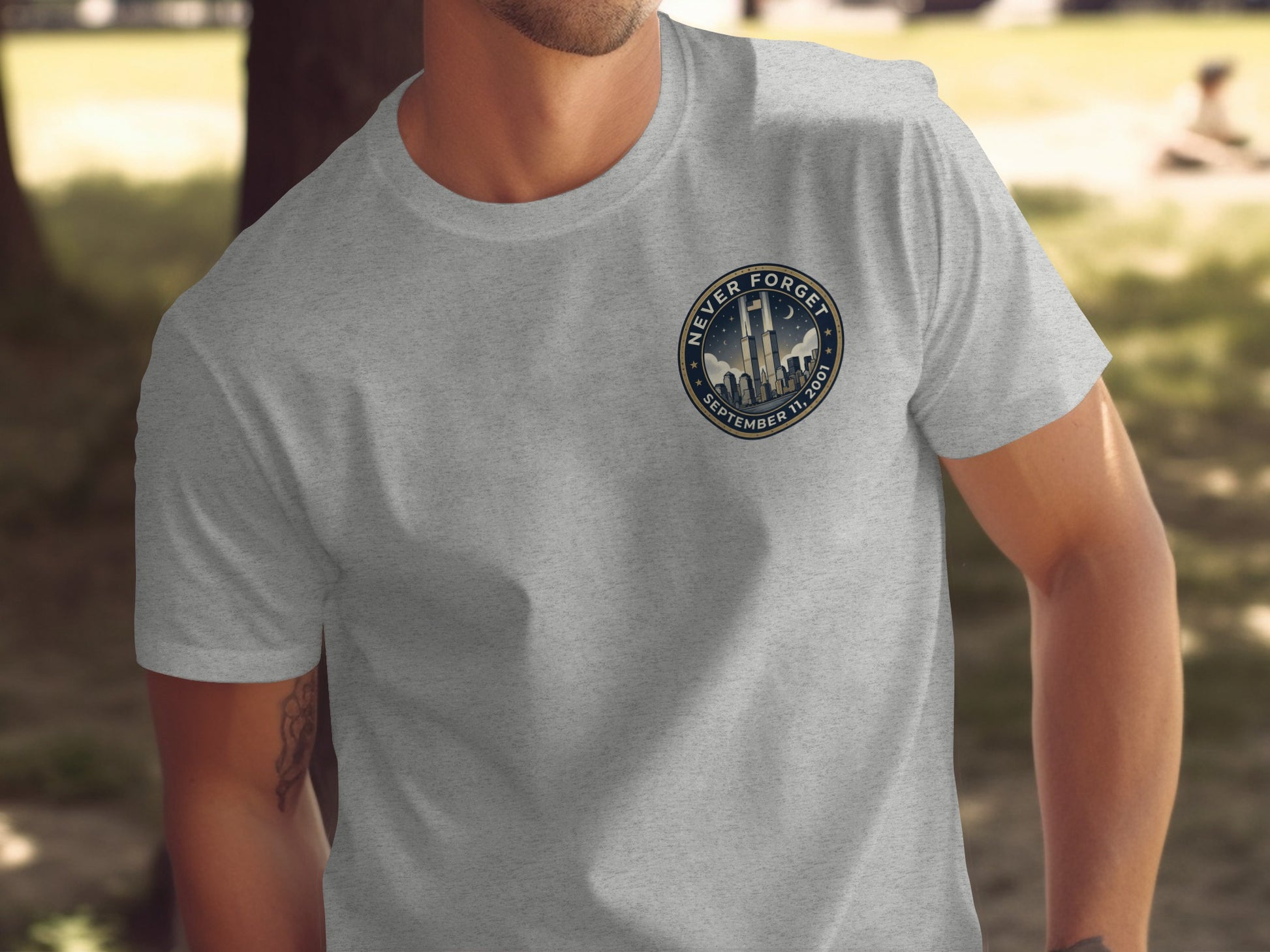Gray t-shirt with "Never Forget September 11, 2001" emblem featuring skyline.