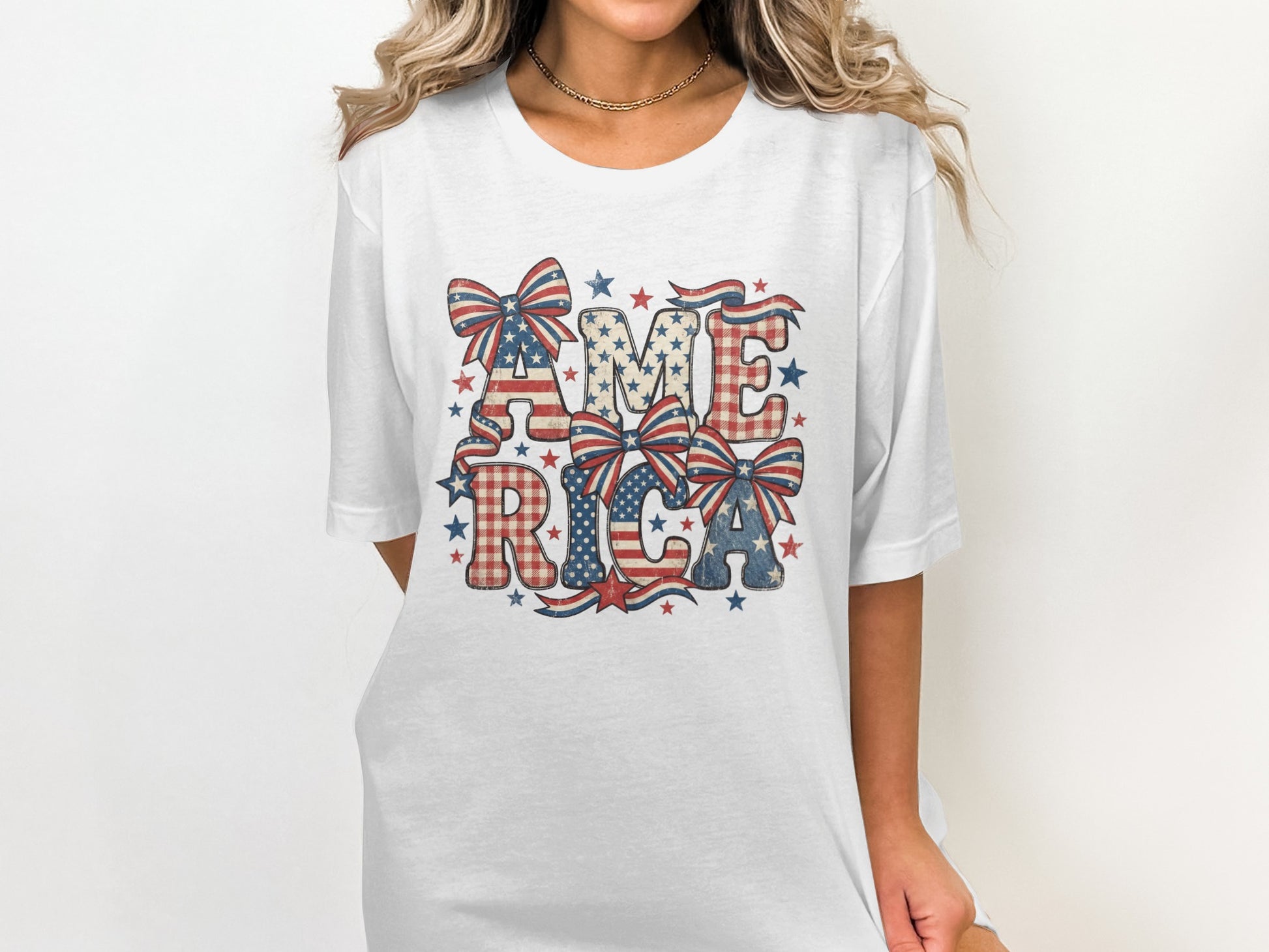 White t-shirt with "AMERICA" in patriotic red, white, and blue checkered letters and stars.