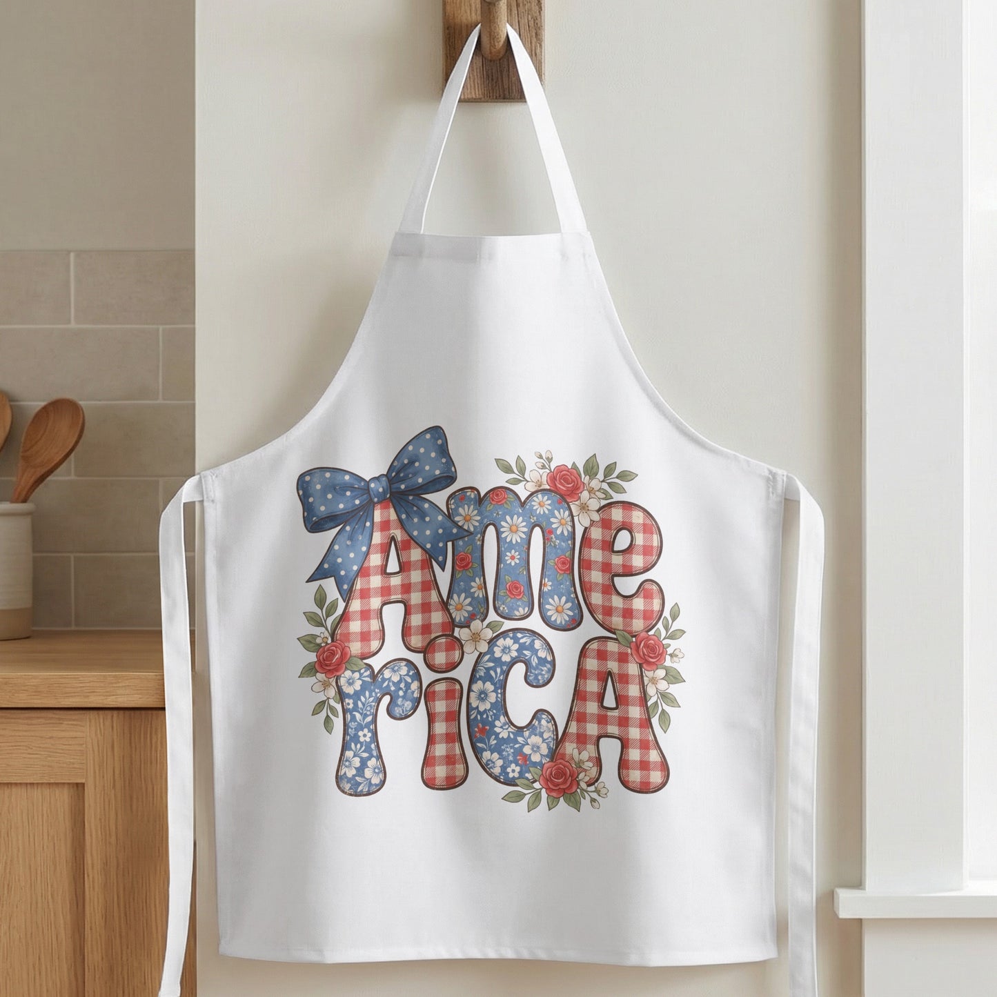 White apron with "America" text in checkered and floral patterns, embellished with a blue bow and flowers.