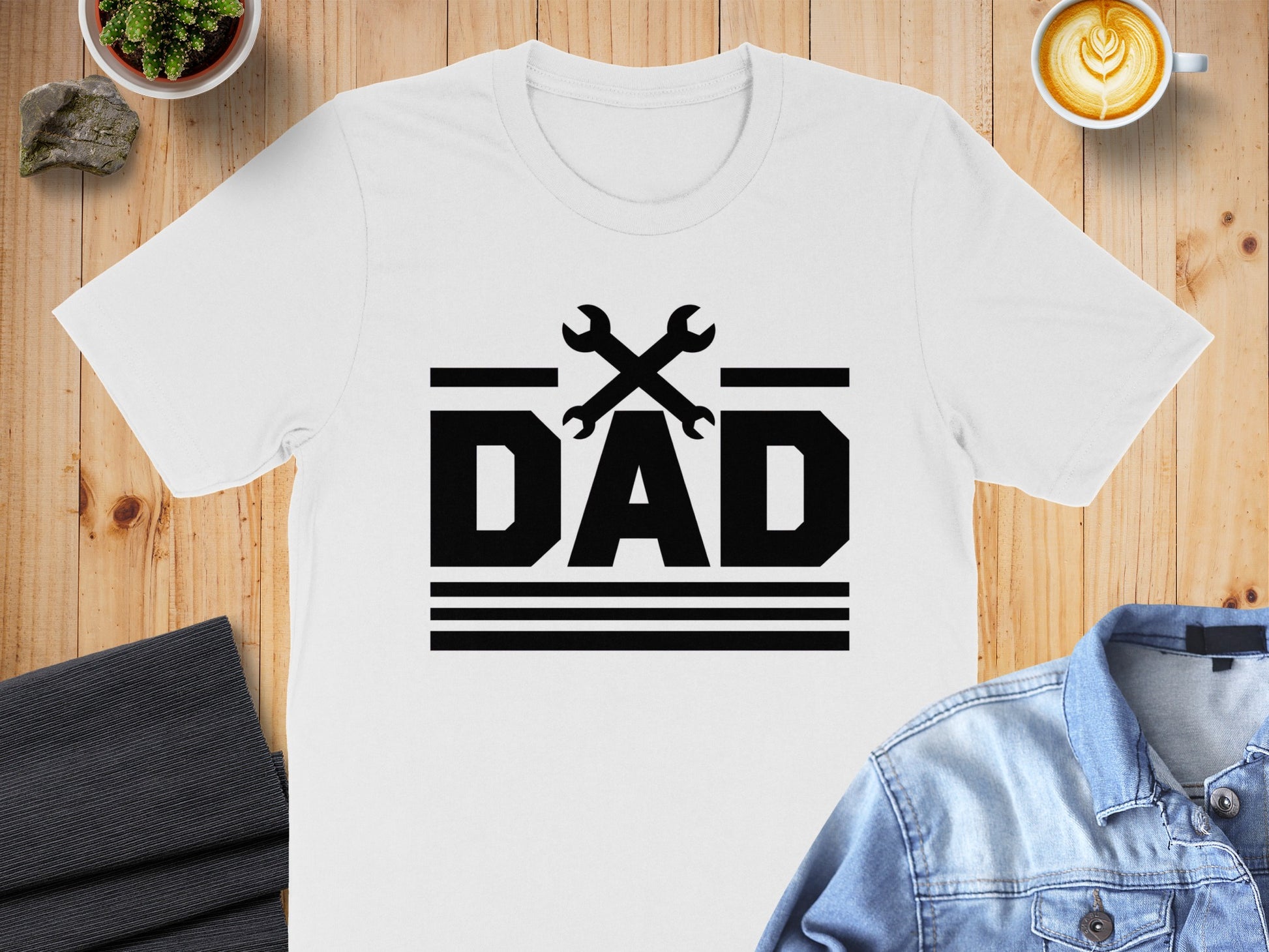 White t-shirt with black "DAD" text and crossed wrenches graphic.