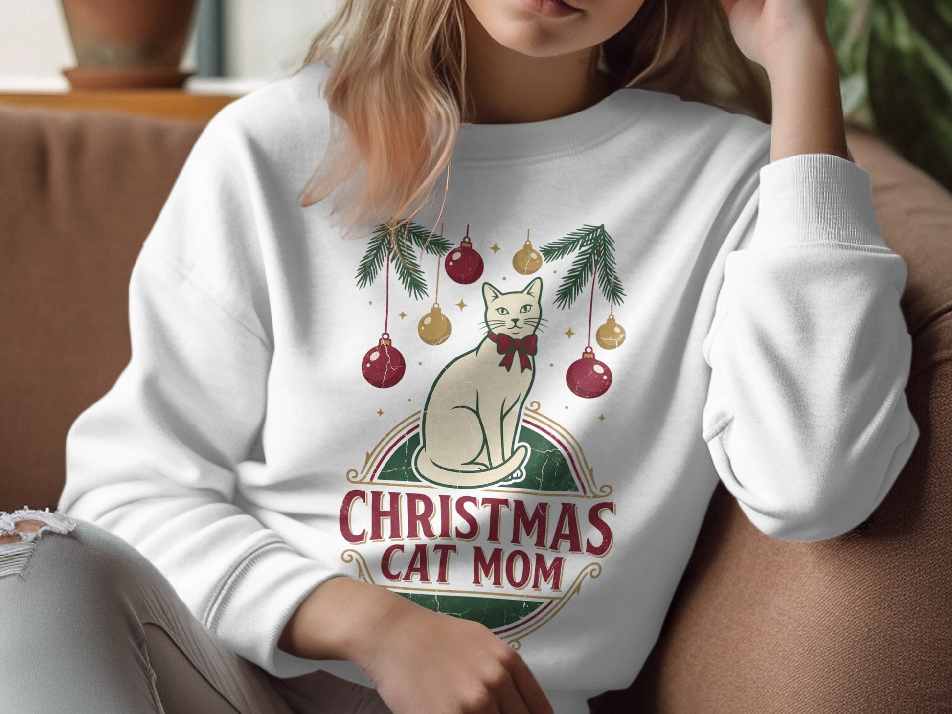 White sweatshirt with a Christmas cat mom graphic featuring a cream cat with a red bow tie.