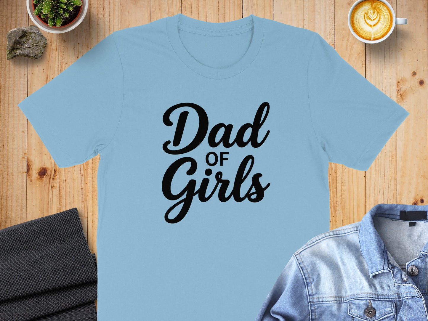 Light blue t-shirt with "Dad of Girls" text in black.