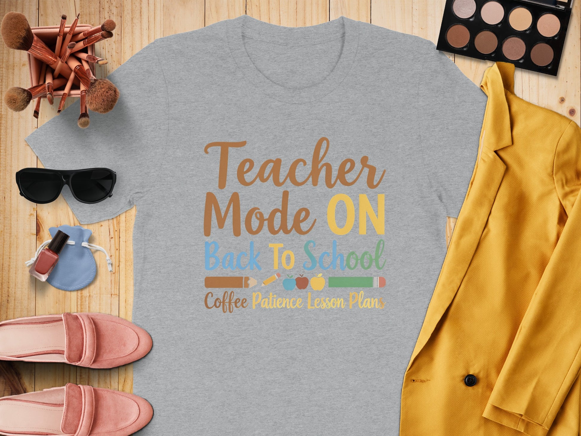 Grey t-shirt with "Teacher Mode ON Back To School Coffee Patience Lesson Plans" text and school supplies.