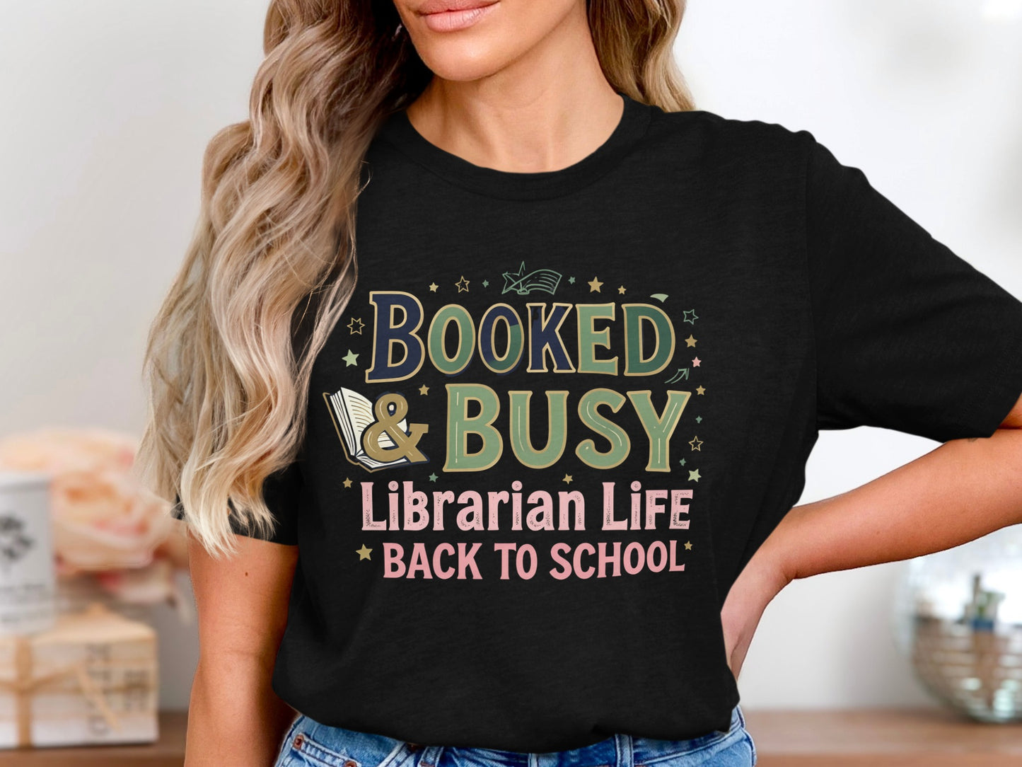 Black t-shirt with "Booked & Busy Librarian Life Back To School" text and design.