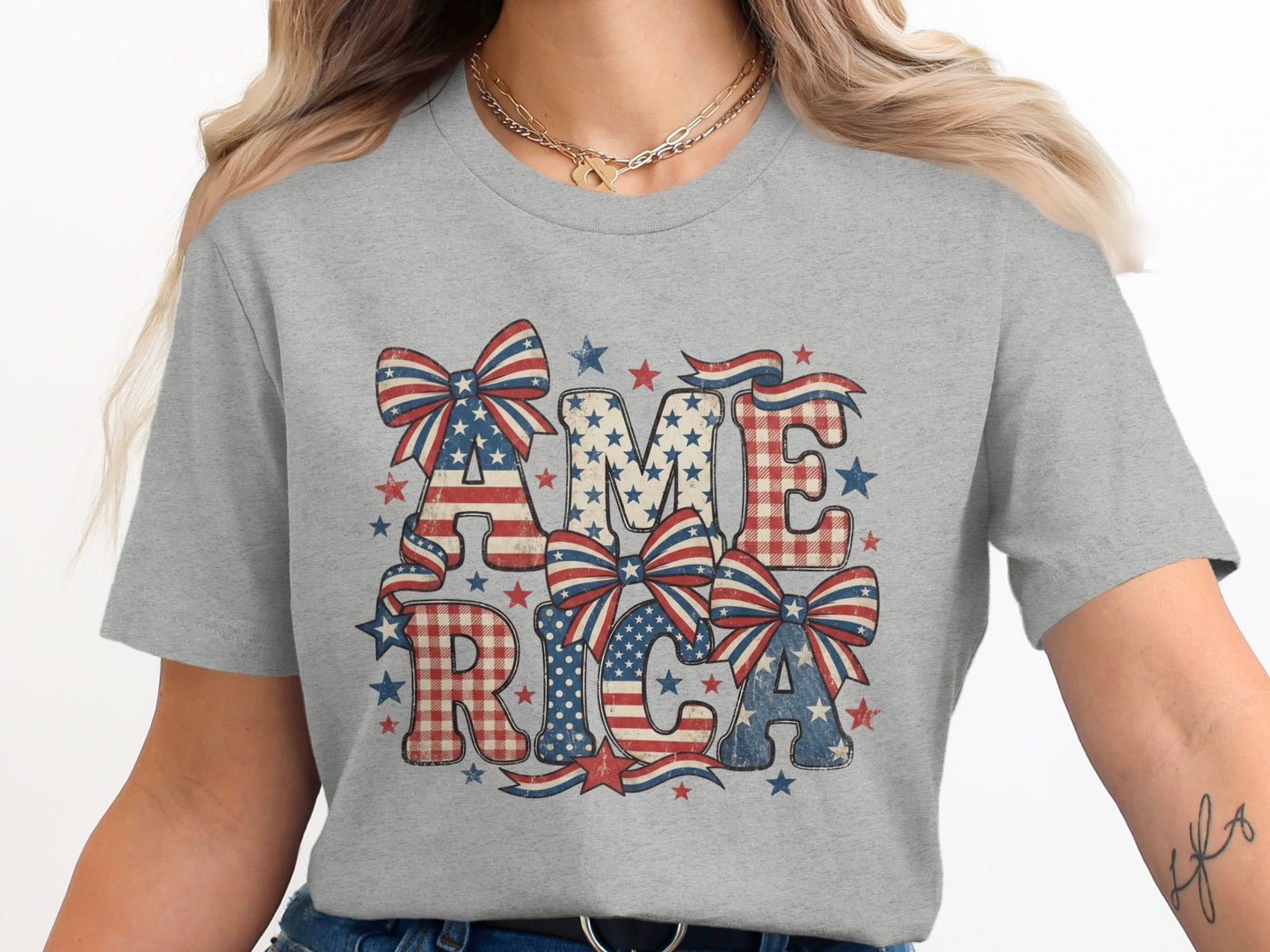 Gray t-shirt with "AMERICA" in patriotic stars and plaid letters with bows.
