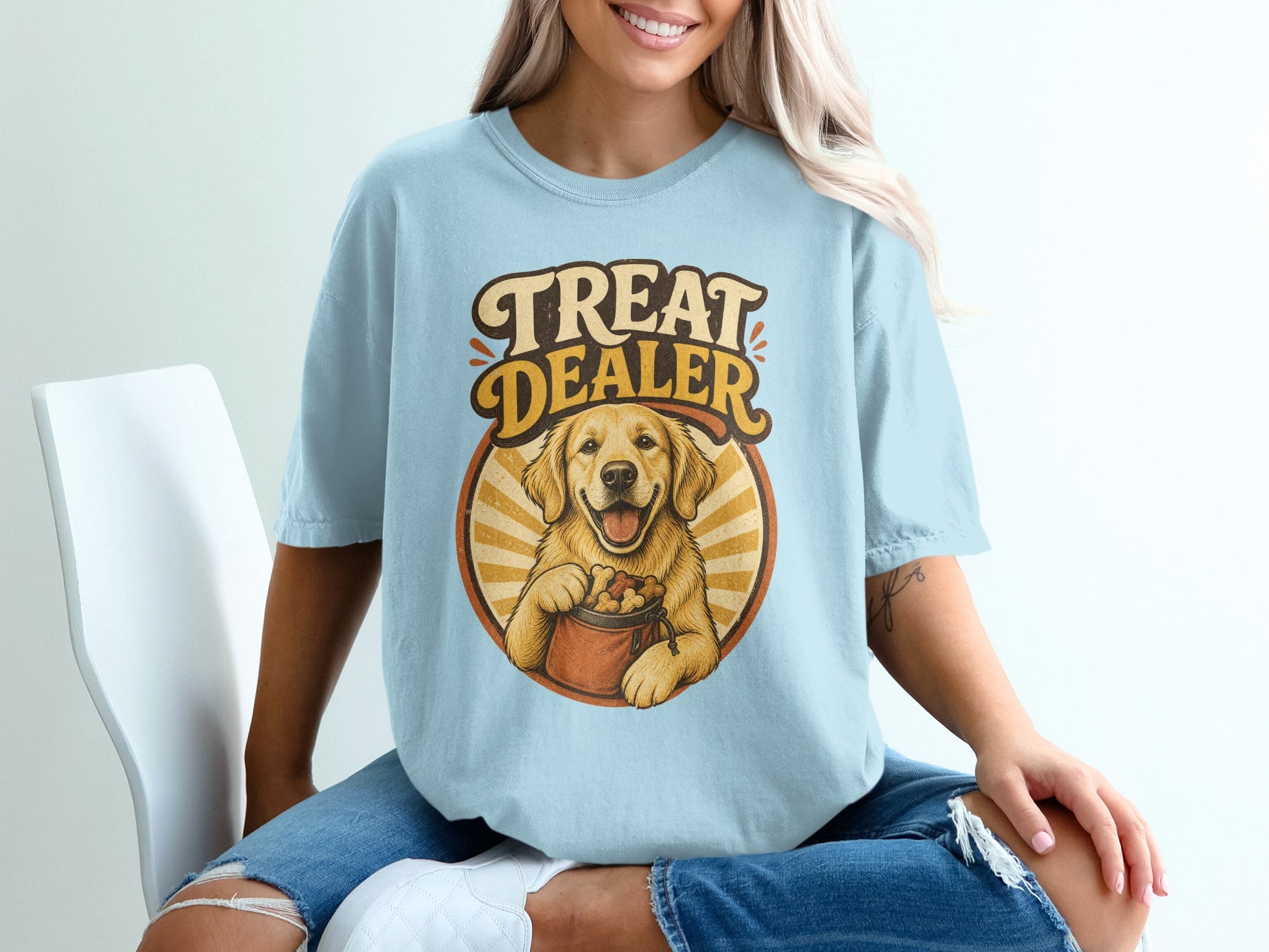 Golden retriever dog graphic with "Treat Dealer" text on light blue t-shirt.