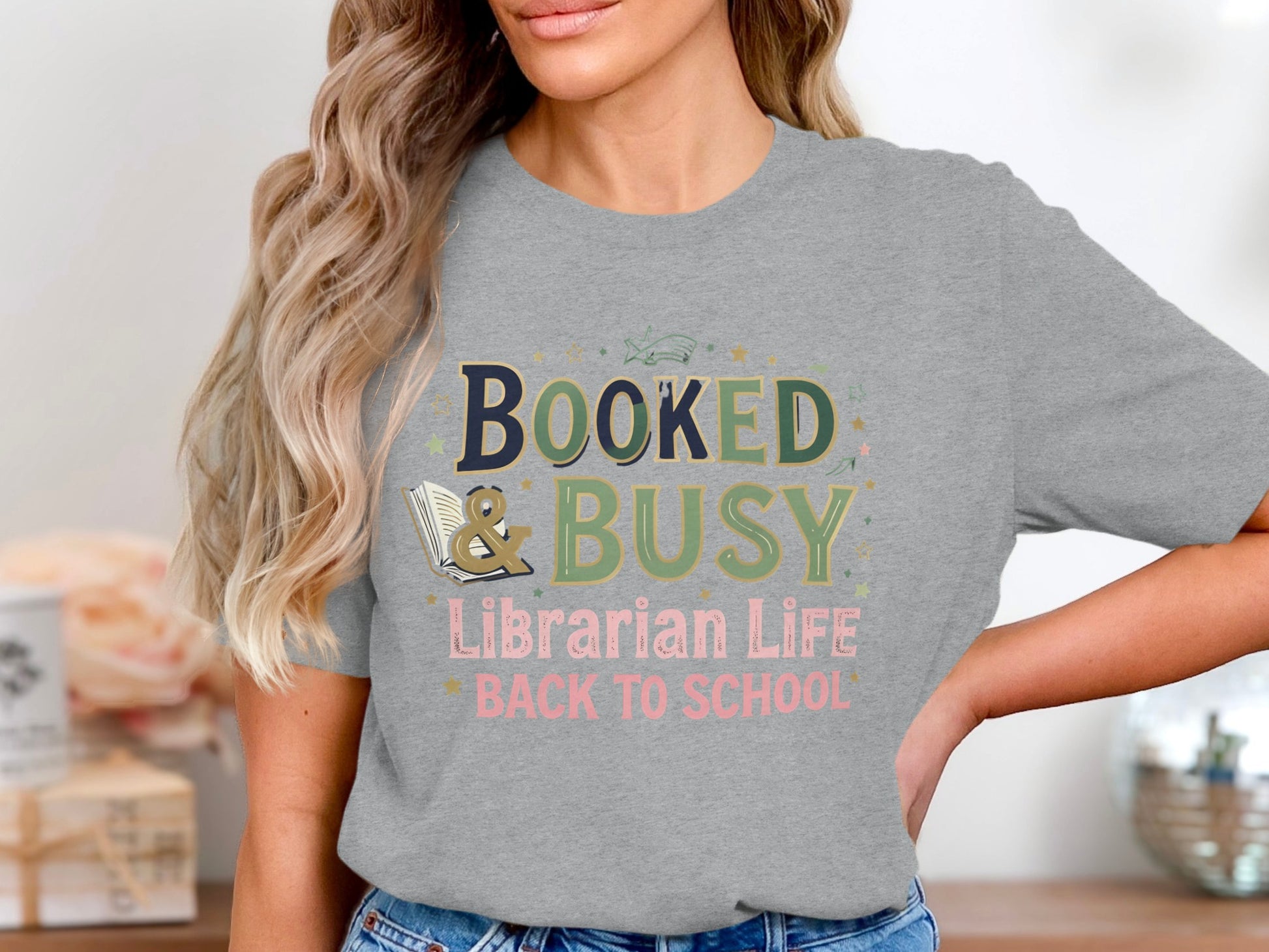 Grey t-shirt with "Booked & Busy Librarian Life Back to School" text and book graphic.