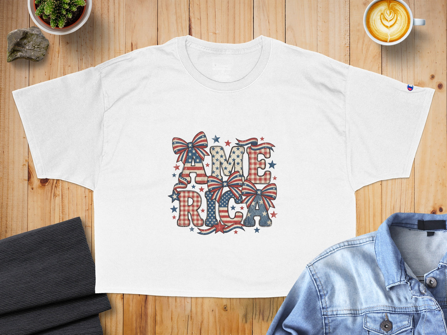 White t-shirt with "AMERICA" text featuring patriotic bows and plaid patterns.