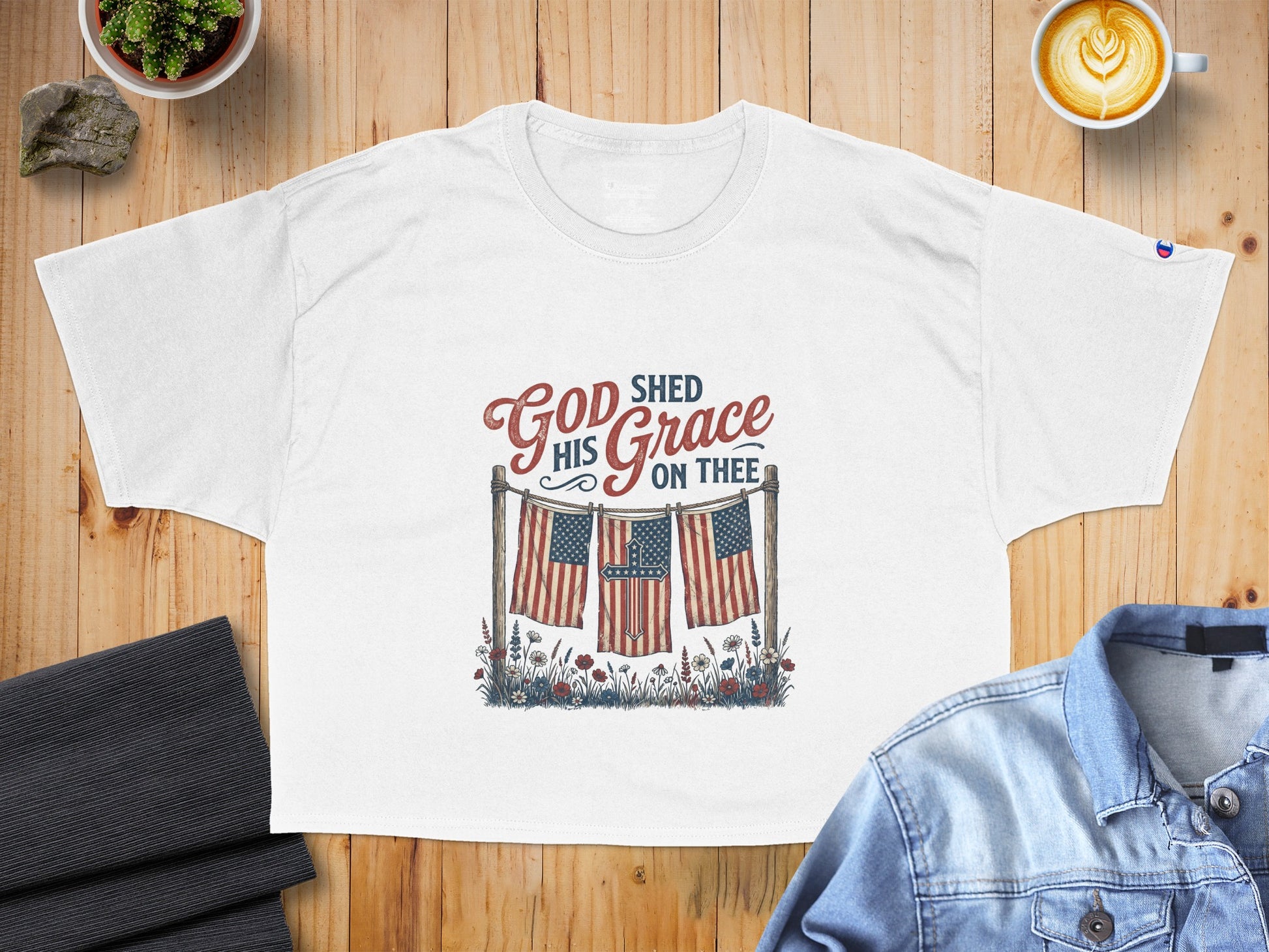 White t-shirt with "God Shed His Grace On Thee" text and American flags.