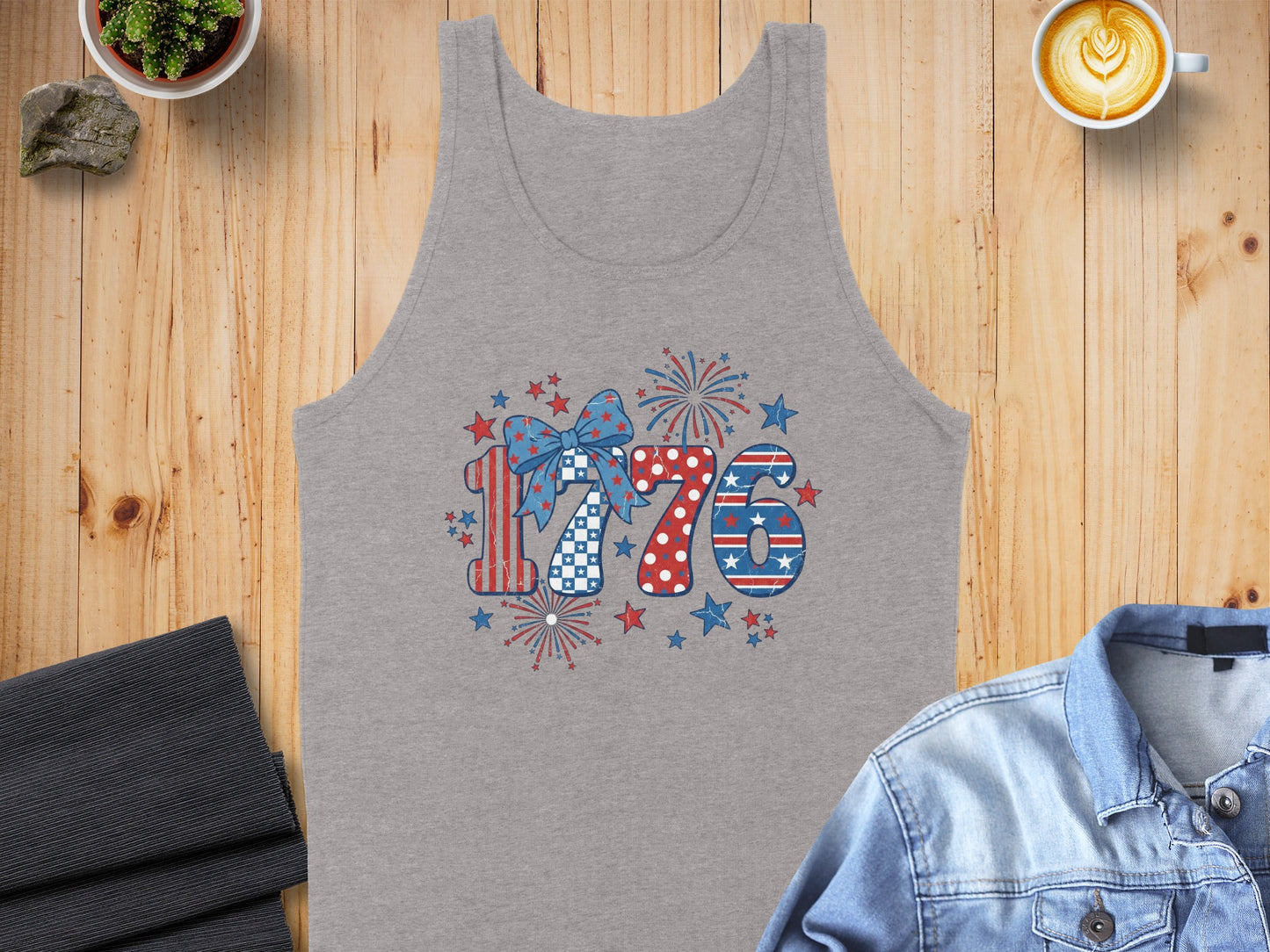 Gray tank top with "1776" graphic featuring patriotic patterns, bow, stars, and fireworks.