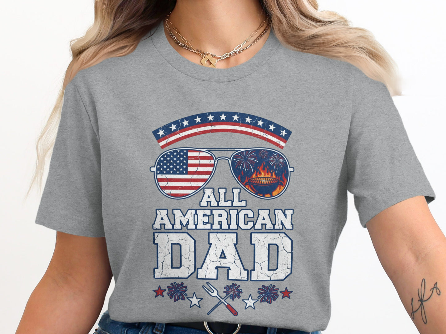 Grey t-shirt with "ALL AMERICAN DAD" text, American flag sunglasses, and grill.