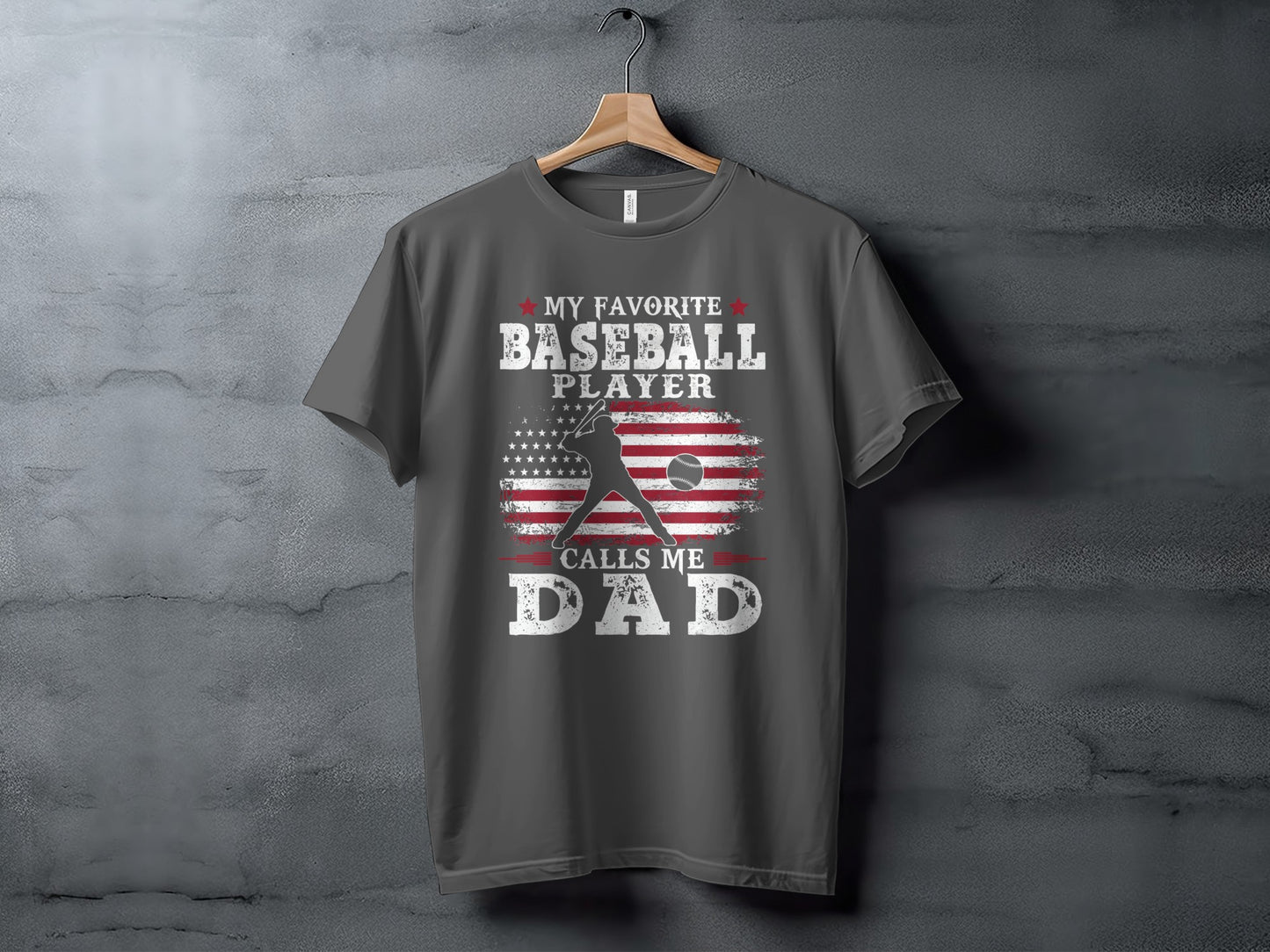 Dark gray t-shirt with "My Favorite Baseball Player Calls Me Dad" and US flag.