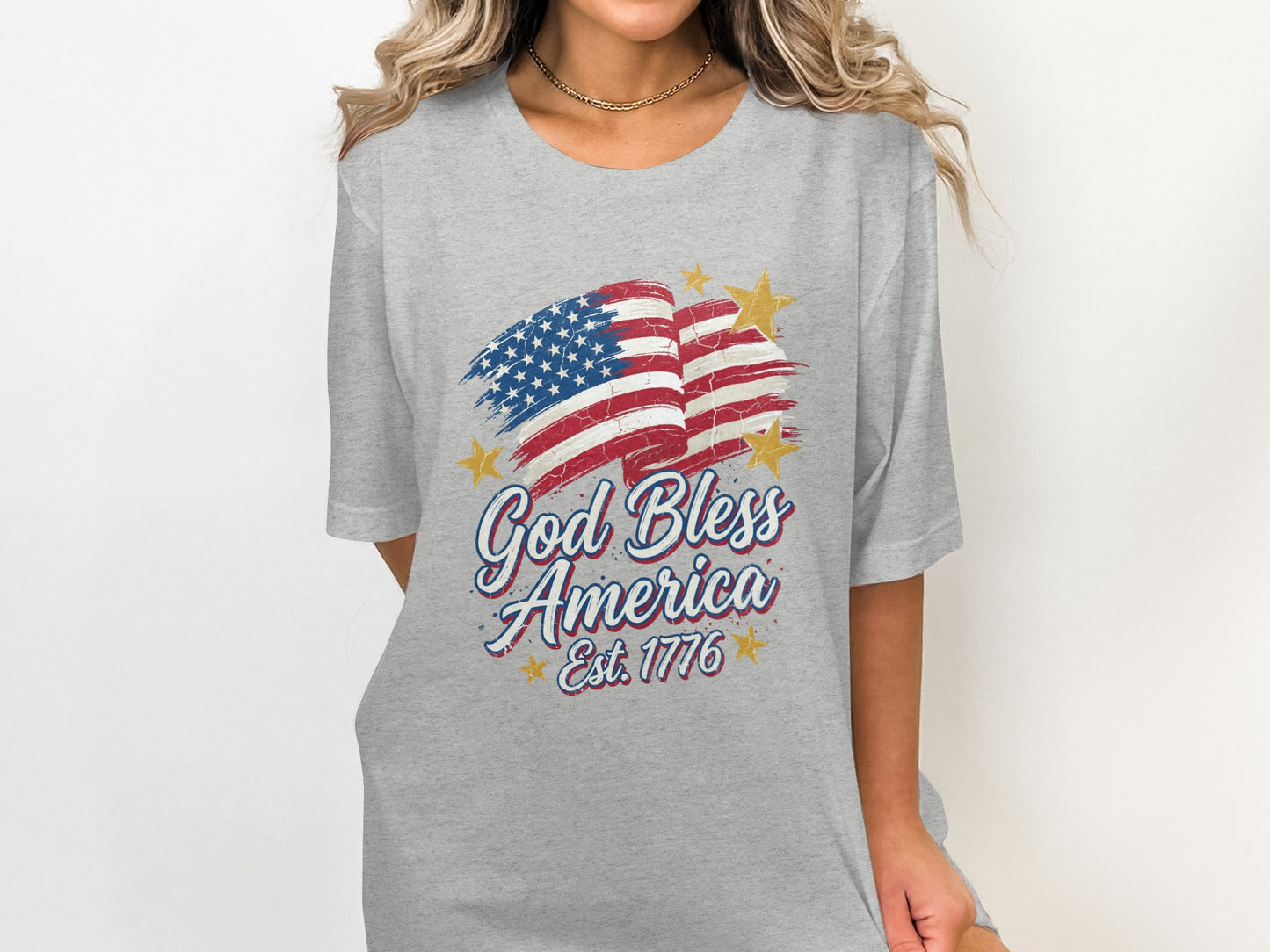 Gray t-shirt with distressed American flag and "God Bless America Est. 1776" text.
