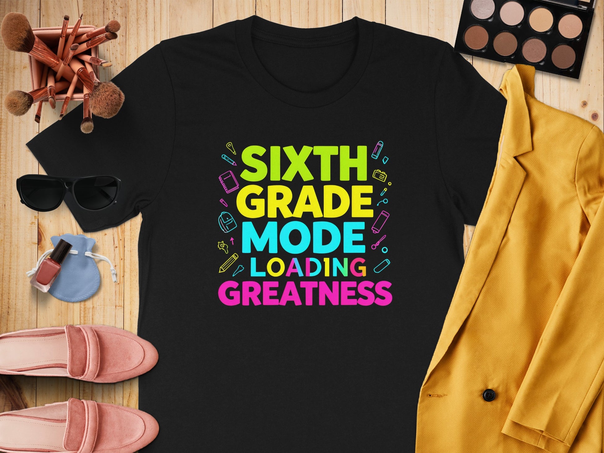 Black t-shirt with colorful text "SIXTH GRADE MODE LOADING GREATNESS"