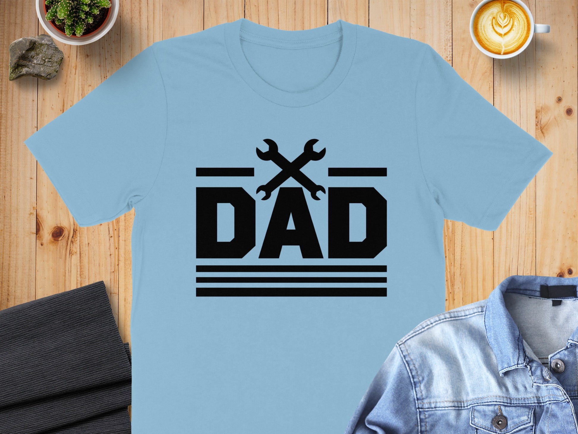 Light blue t-shirt with black "DAD" text and crossed wrenches graphic.