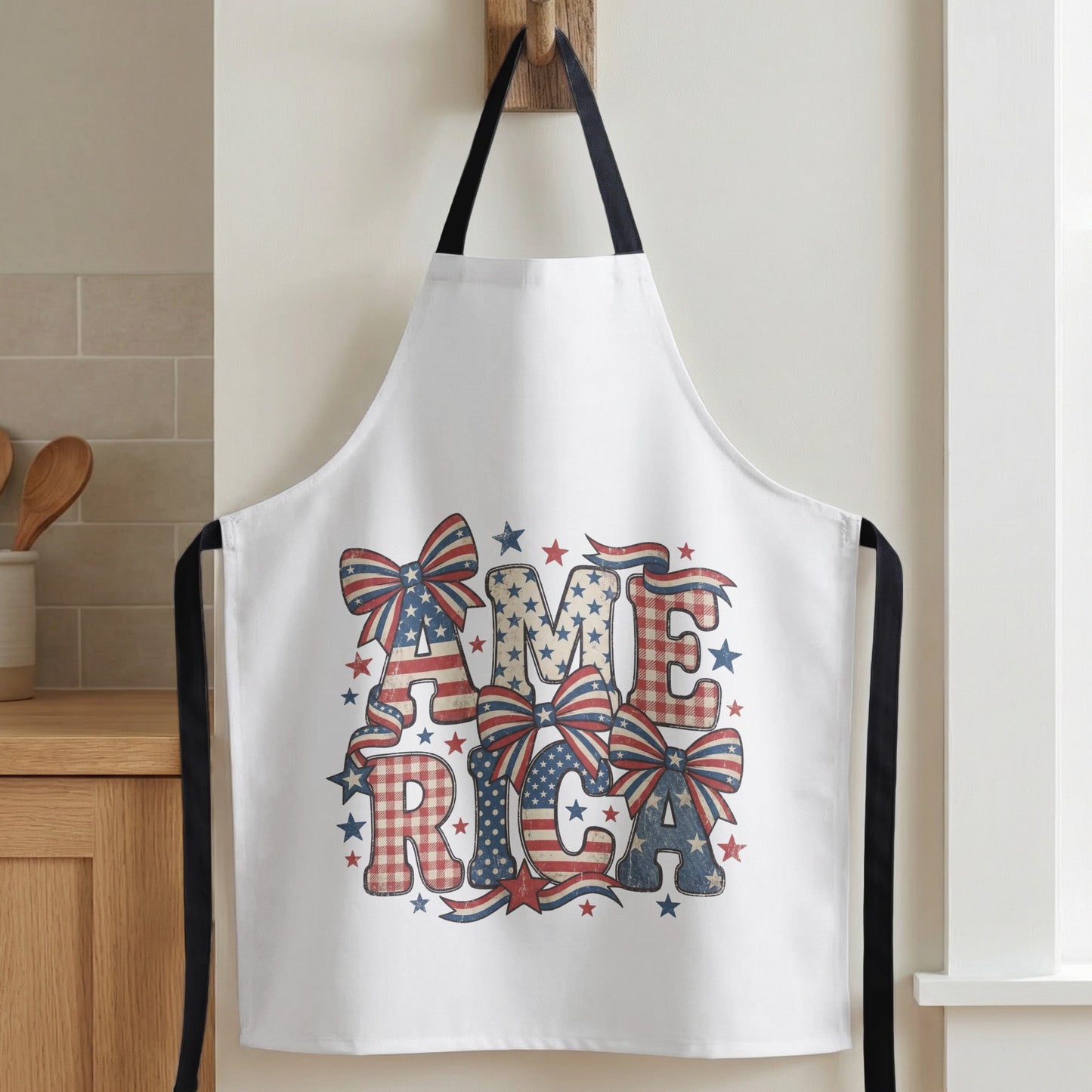 White apron with patriotic "America" text and bow designs.