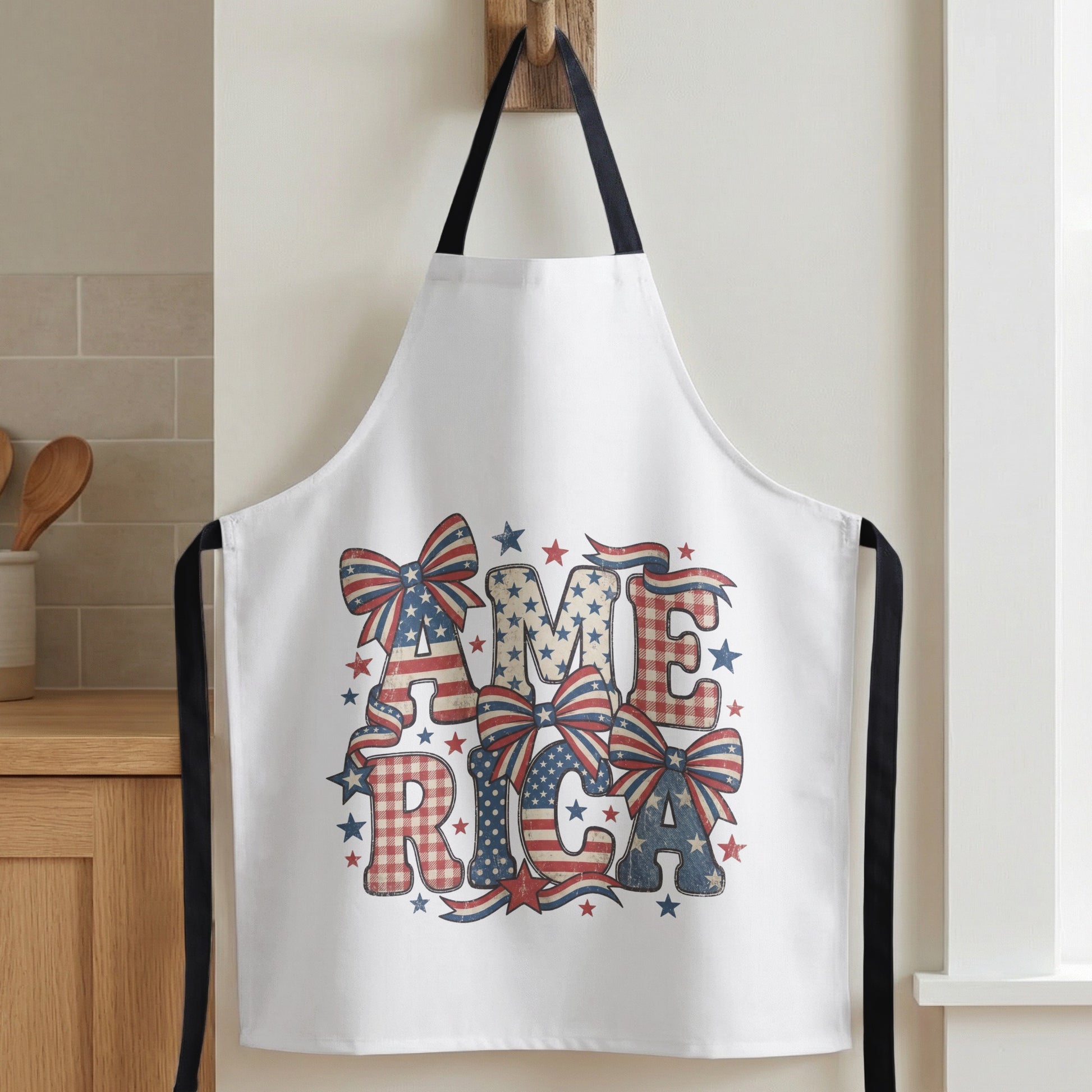 White apron with patriotic "America" text and bow designs.