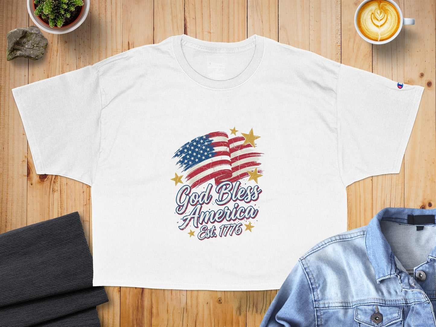 White t-shirt with distressed American flag and "God Bless America Est. 1776" text.