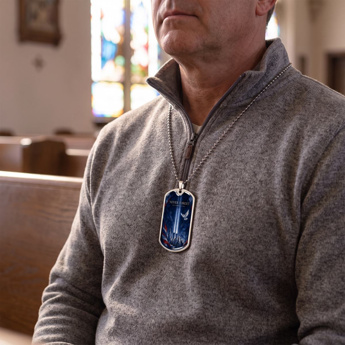 Man wearing the Never Forget 9/11 stained glass dog tag necklace in a church with stained glass light