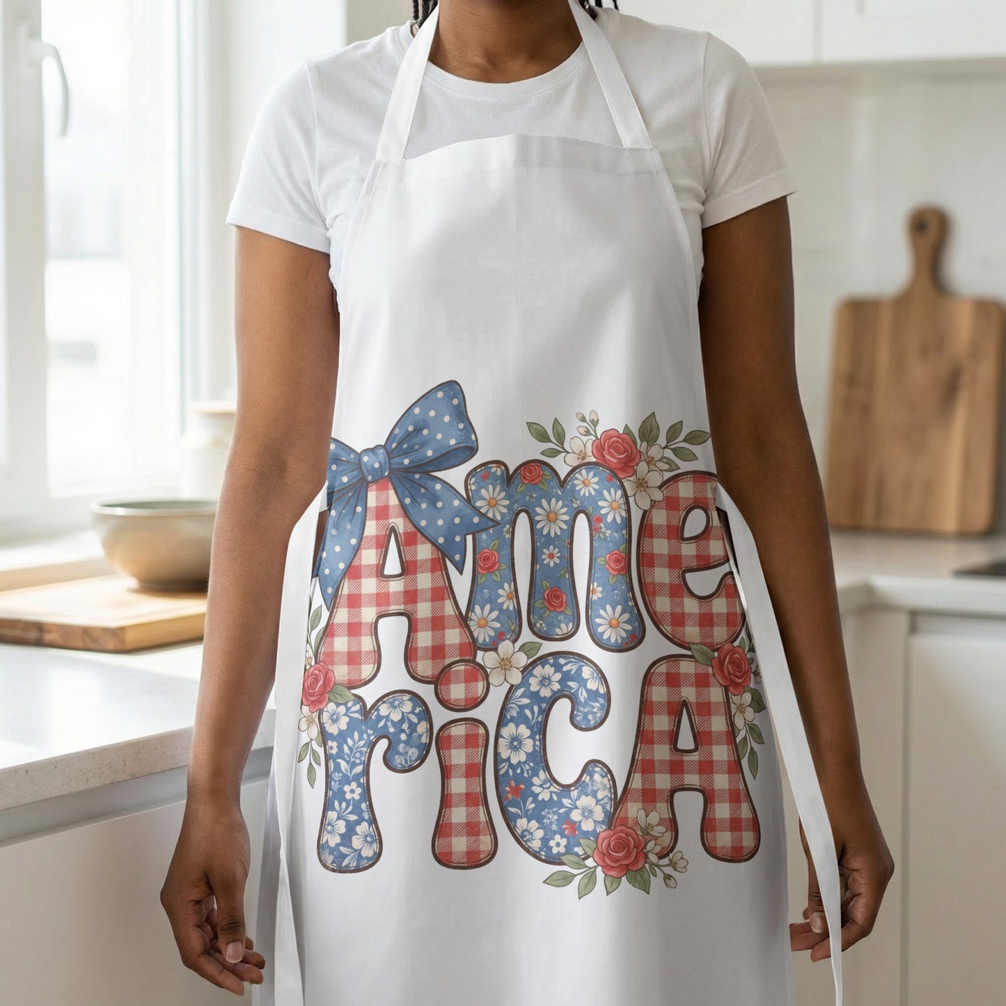 White apron with a blue polka dot bow and text "America" surrounded by flowers.