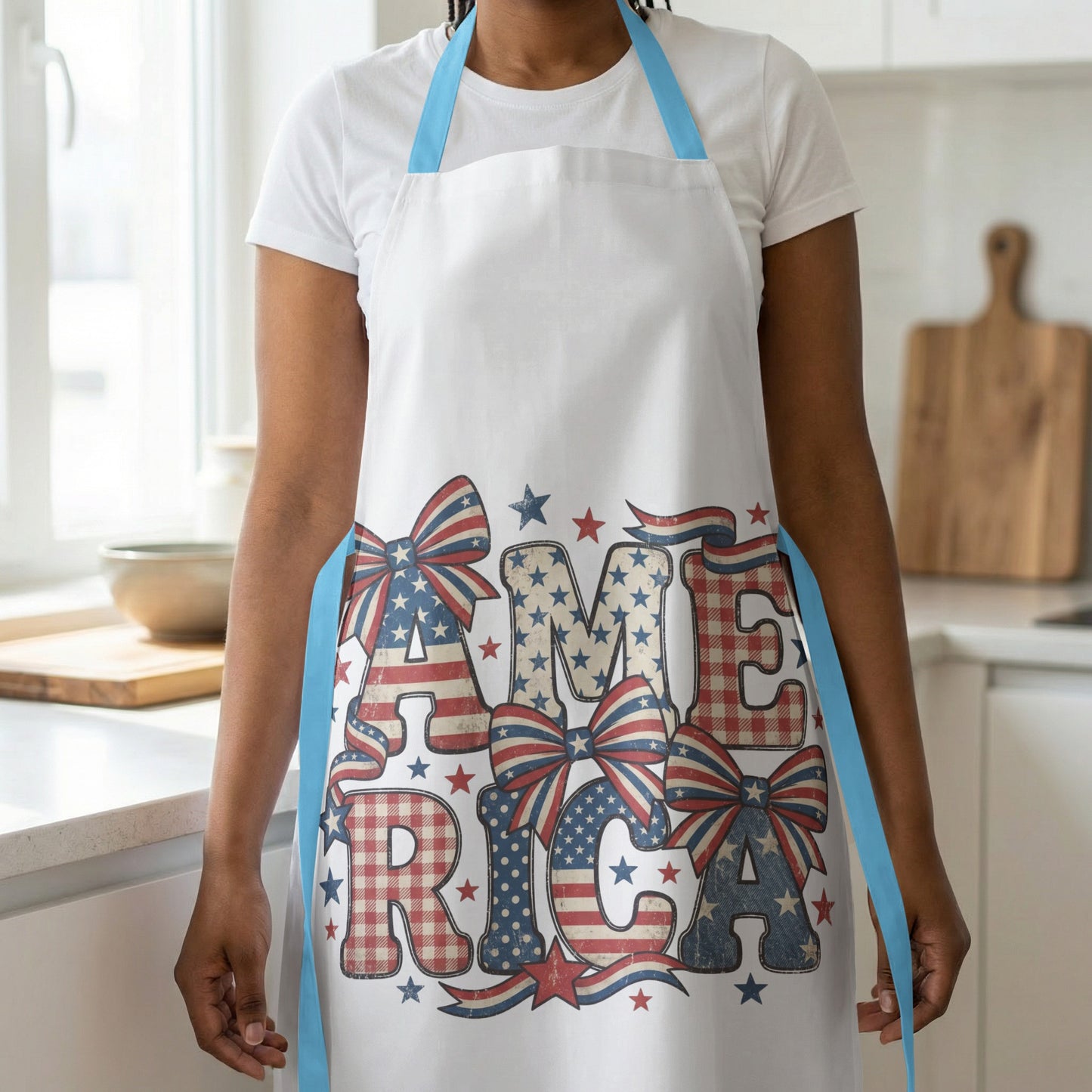 White apron with "America" in patriotic patterned letters and bows.