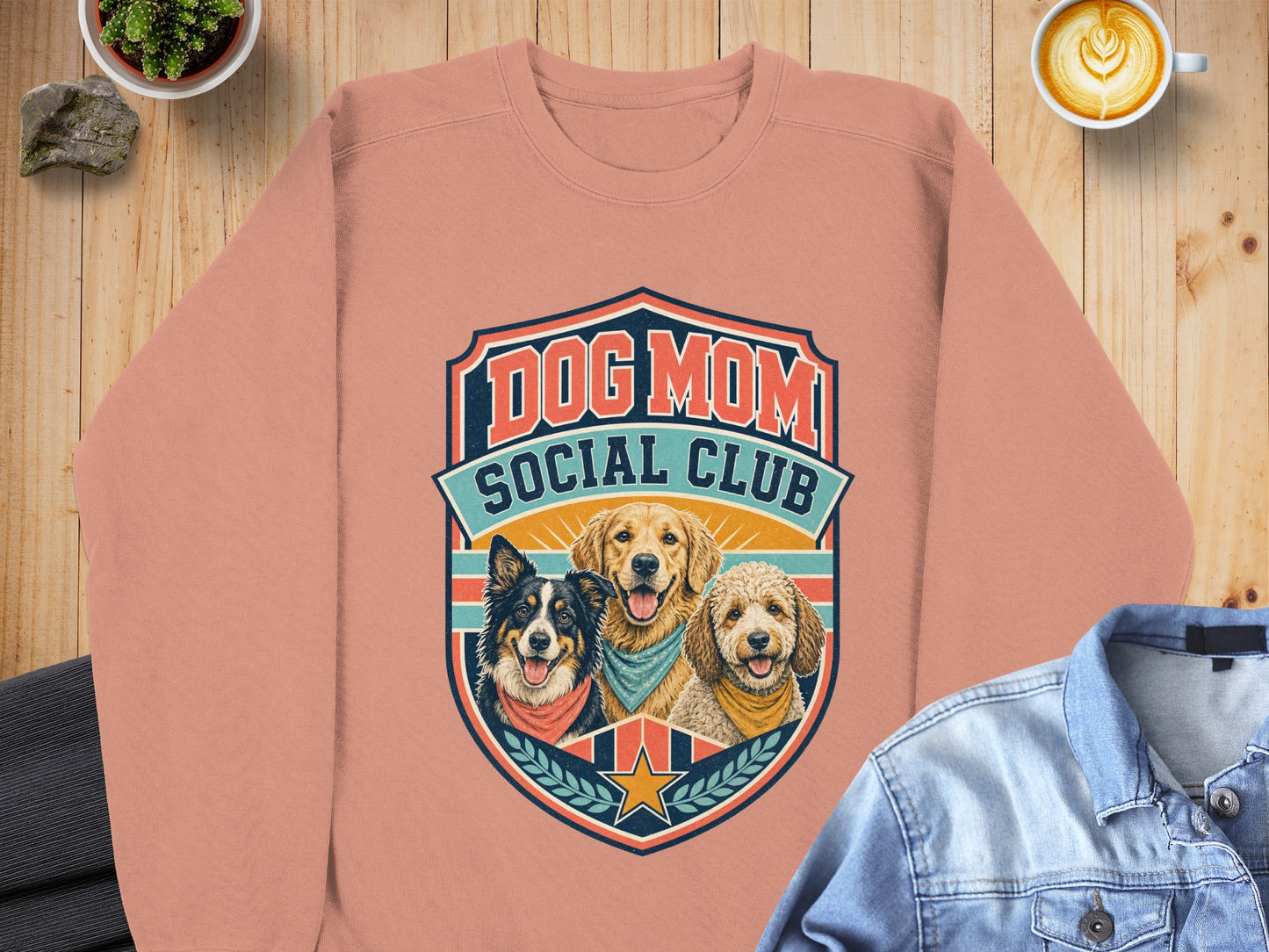 Peach crewneck sweatshirt with "Dog Mom Social Club" text and three dog portraits.