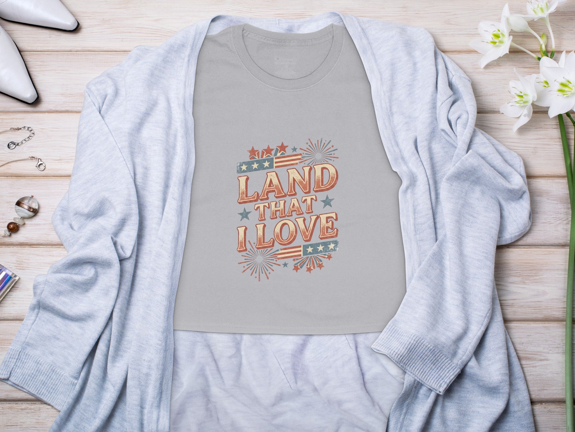 Gray t-shirt with "Land That I Love" text and patriotic graphic.