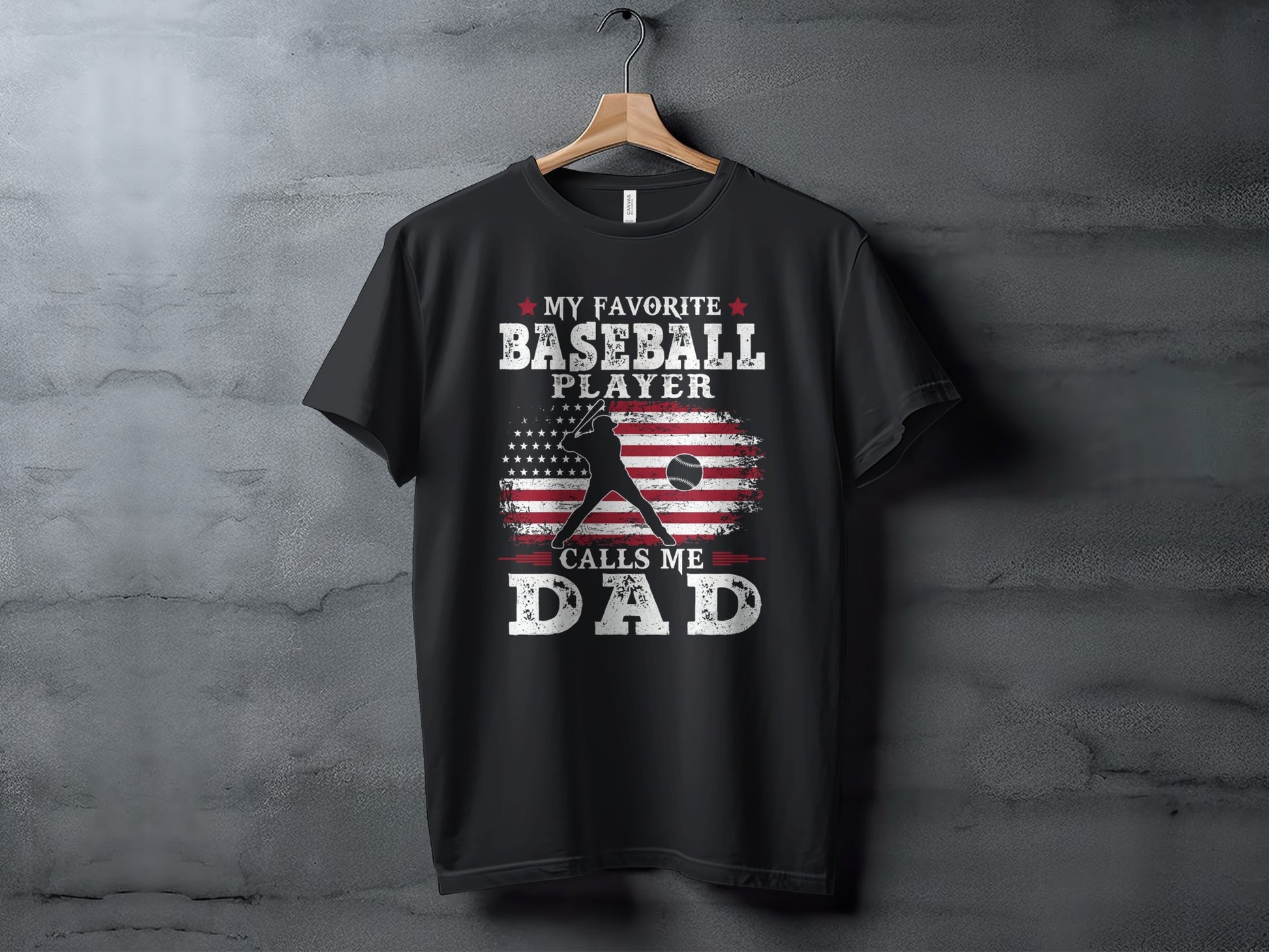 Black t-shirt with "My Favorite Baseball Player Calls Me Dad" and American flag design.