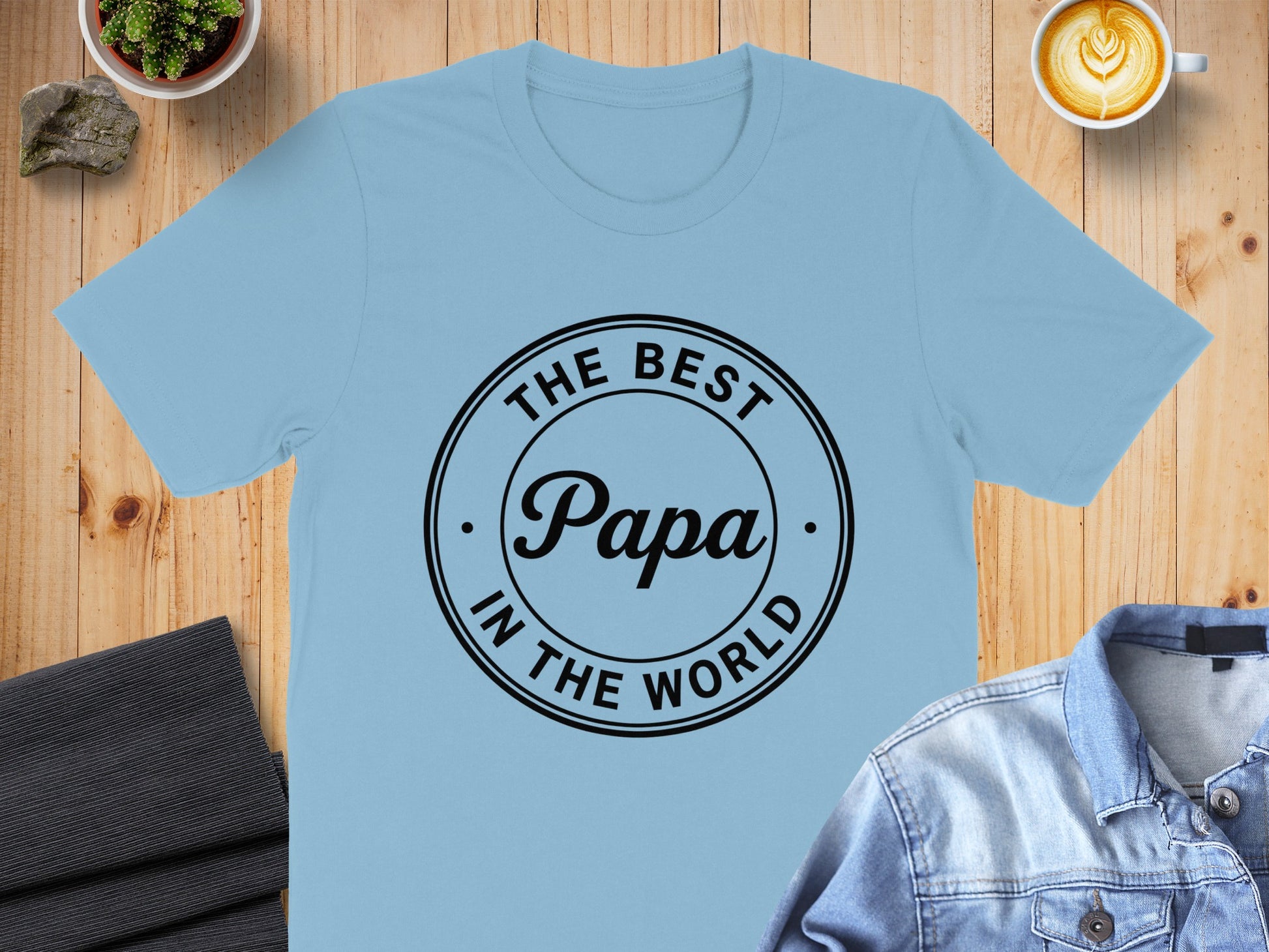 Light blue t-shirt with "THE BEST Papa IN THE WORLD" text in a circle.