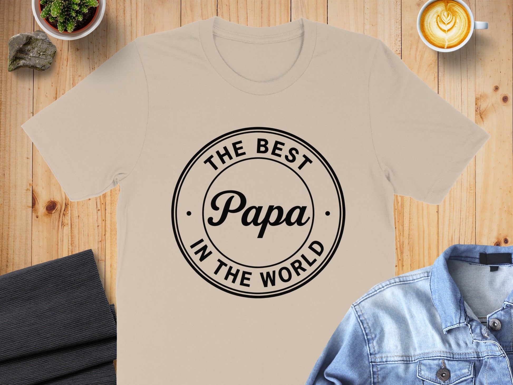 Beige t-shirt with "The Best Papa in the World" text in a circle.