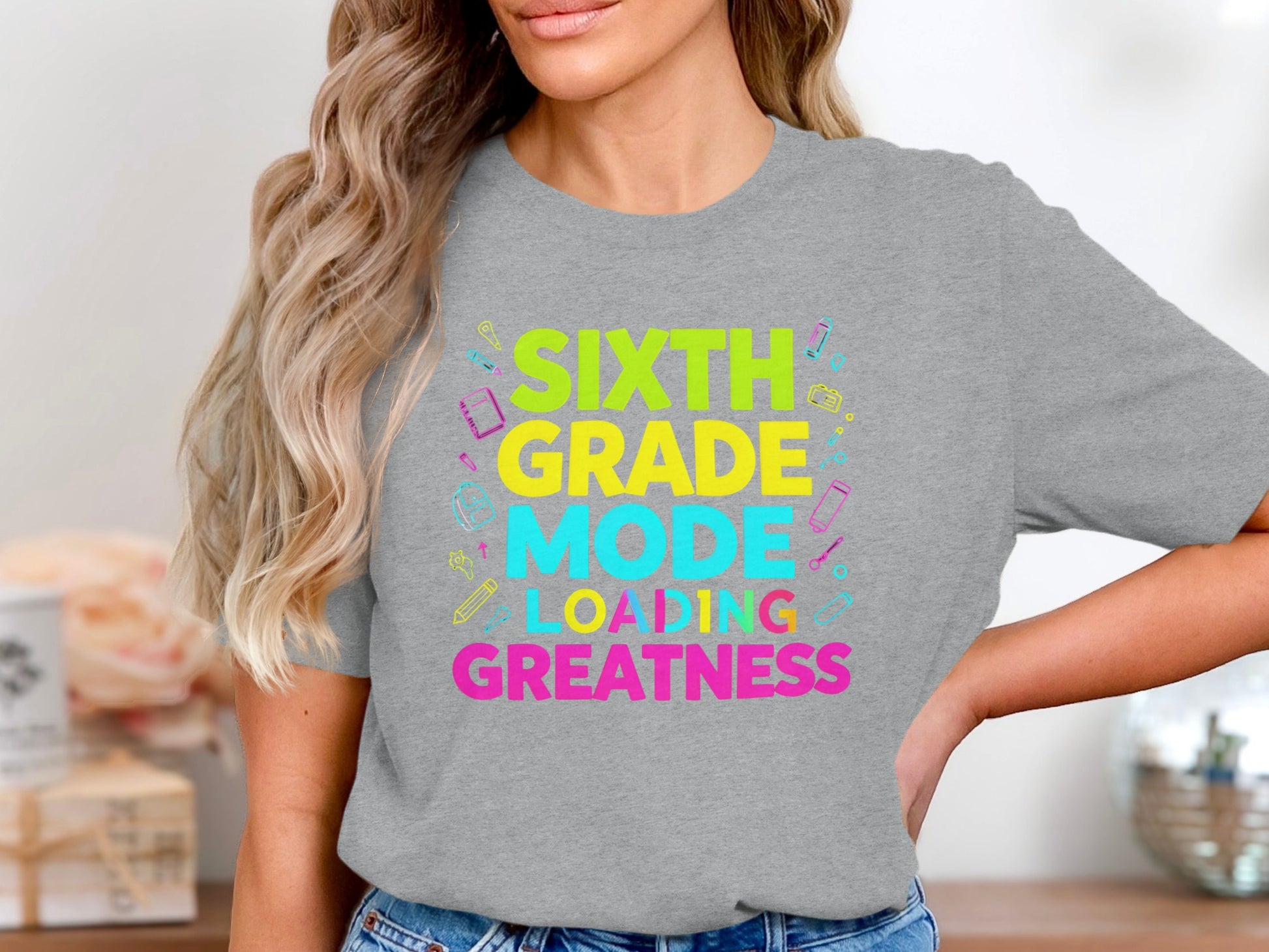 Gray t-shirt with colorful text reading: Sixth Grade Mode Loading Greatness.