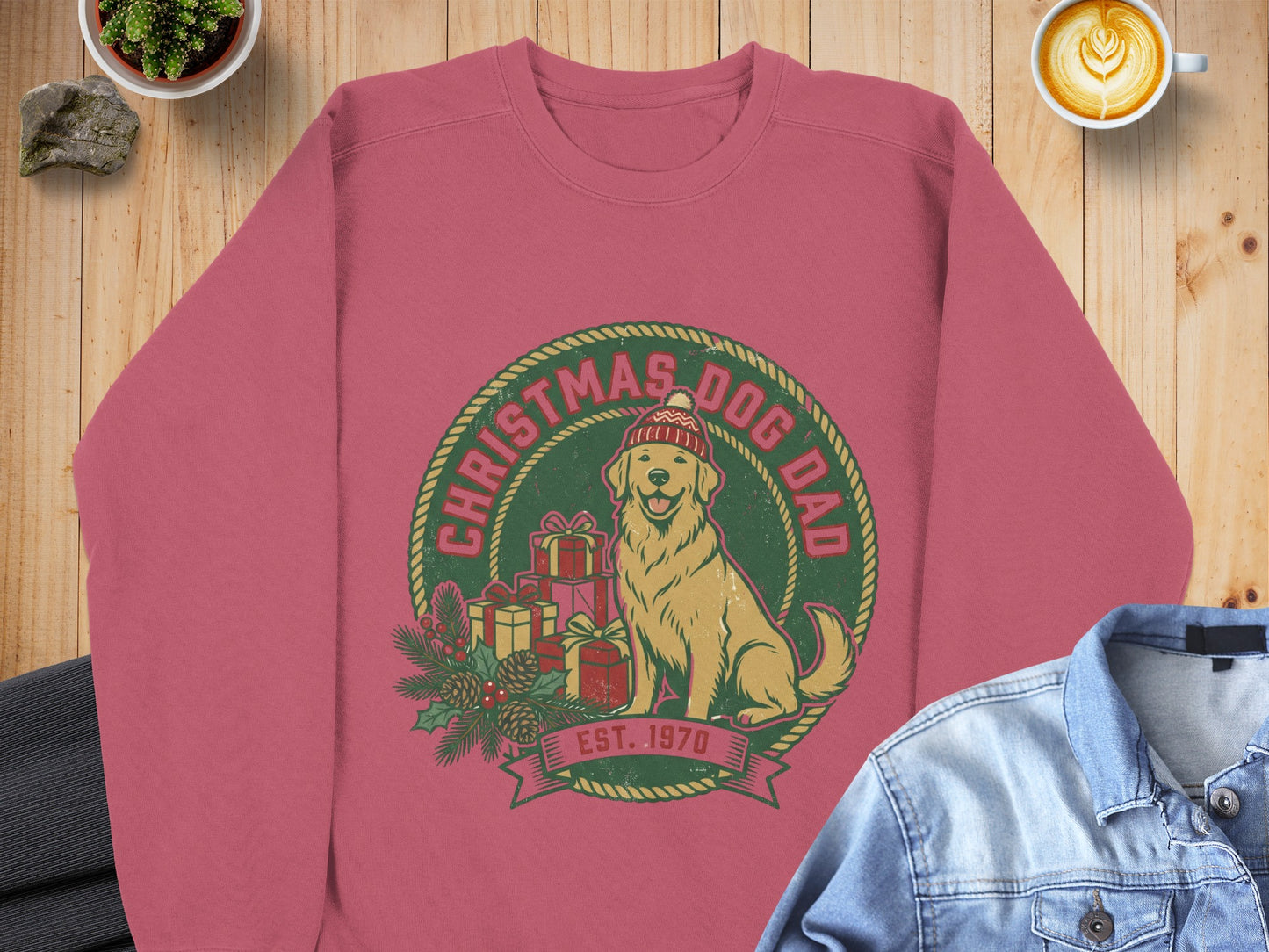 Christmas Dog Dad graphic on a pink crewneck sweatshirt with gifts and a dog.