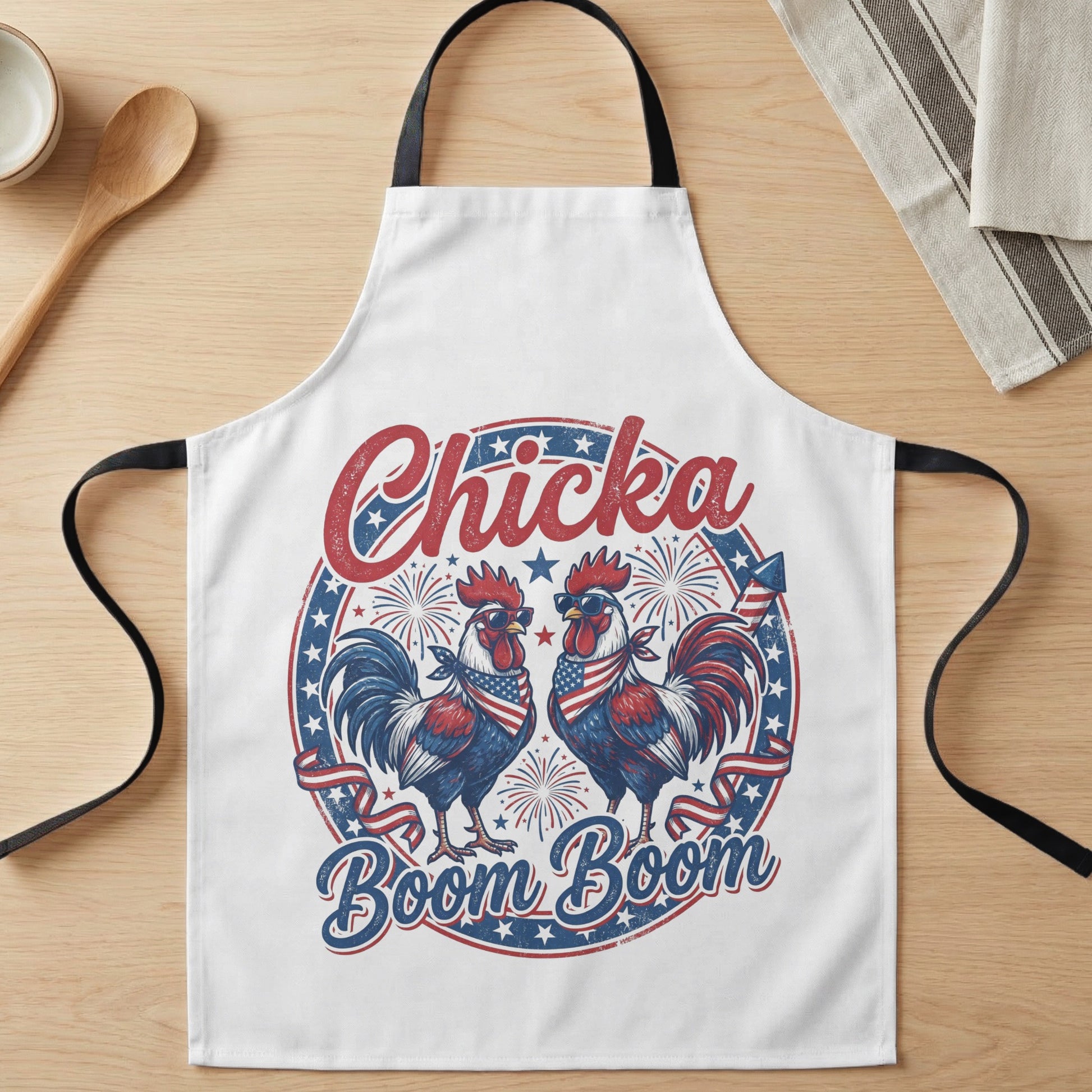 Apron with two roosters in sunglasses and American flag bandanas, text "Chicka Boom Boom".