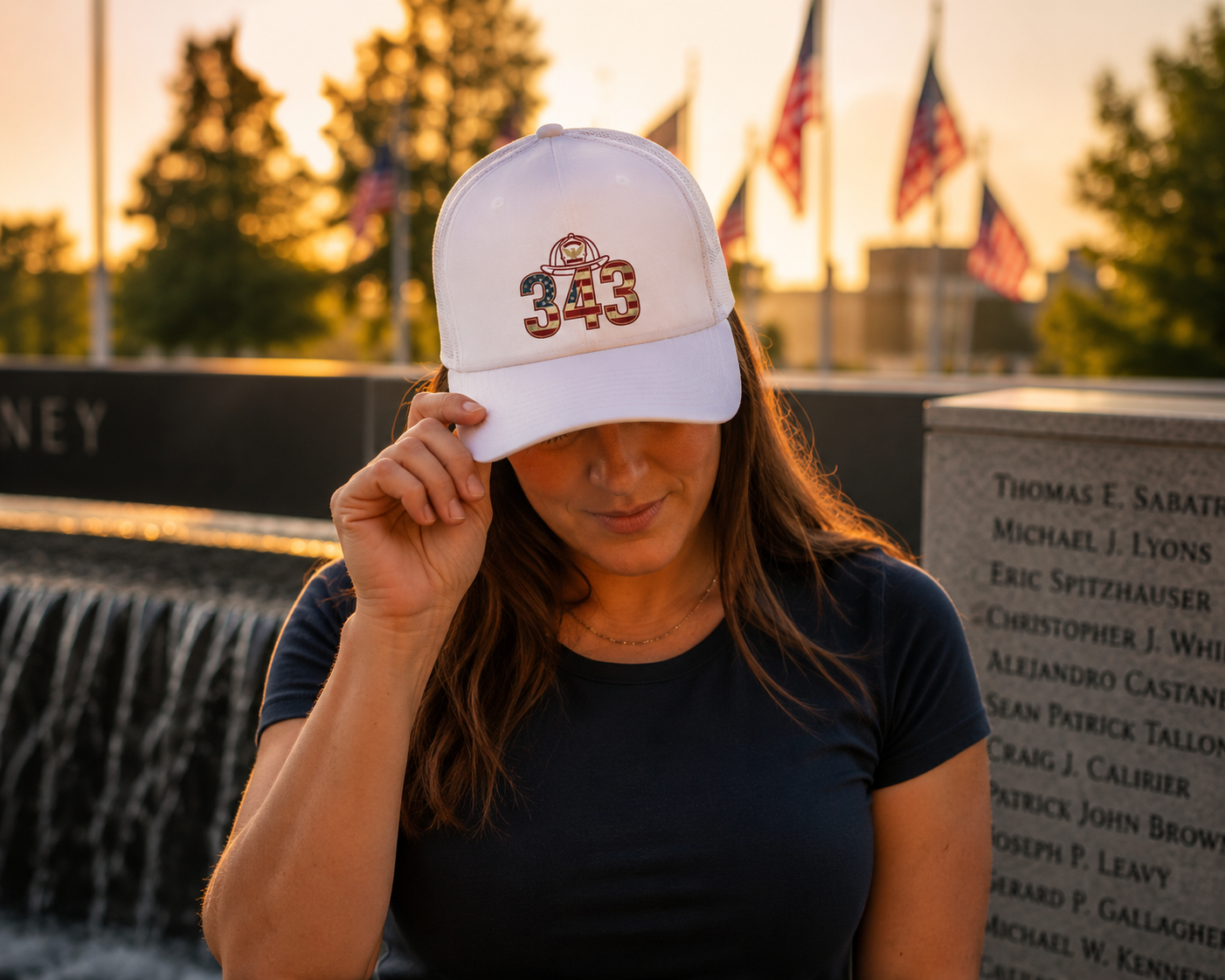 Lifestyle mockup - Vigilant Spirit 343 Tribute Hat at memorial fountain